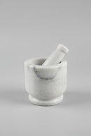 A white marble mortar and pestle set re