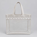 A light beige woven jute tote bag with a clear plastic window panel and lace trim, 