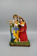 A colorful figurine of Lord Krishna and Radha .