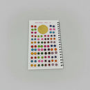 A sheet of spiral-bound sticker embellishments labeled 'SPIRAL No. 2' on a dark wooden table.