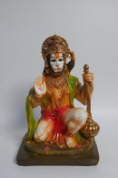 Statue of Lord Hanuman seated on a base.