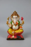 A colorful Ganesha statue seated on a lotus base.